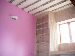 Old cottage with distemper on exposed beams, and vibrant chalky wall paint